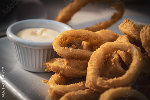 Fried calamares with alioli, typical snack served in the most of Spanish beach bars on Malaga coast. photo