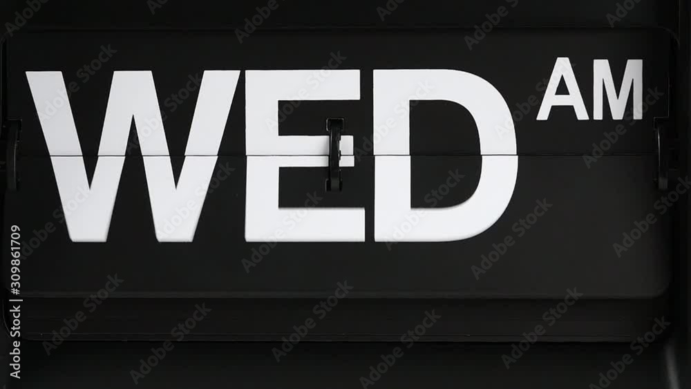 Close-up Slow Motion, Retro flip clock calendar changing label days Tuesday pm. to Wednesday am., Time concept. Close-up Slow Motion, Retro flip clock calendar changing label days Tuesday pm. to Wednesday am., Time concept.