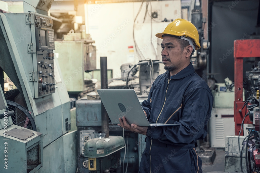 Engineers wear safety helmets, hold computers to control production, stand in front of forklifts in factories. Engineers wear safety helmets, hold computers to control production, stand in front of forklifts in factories.
