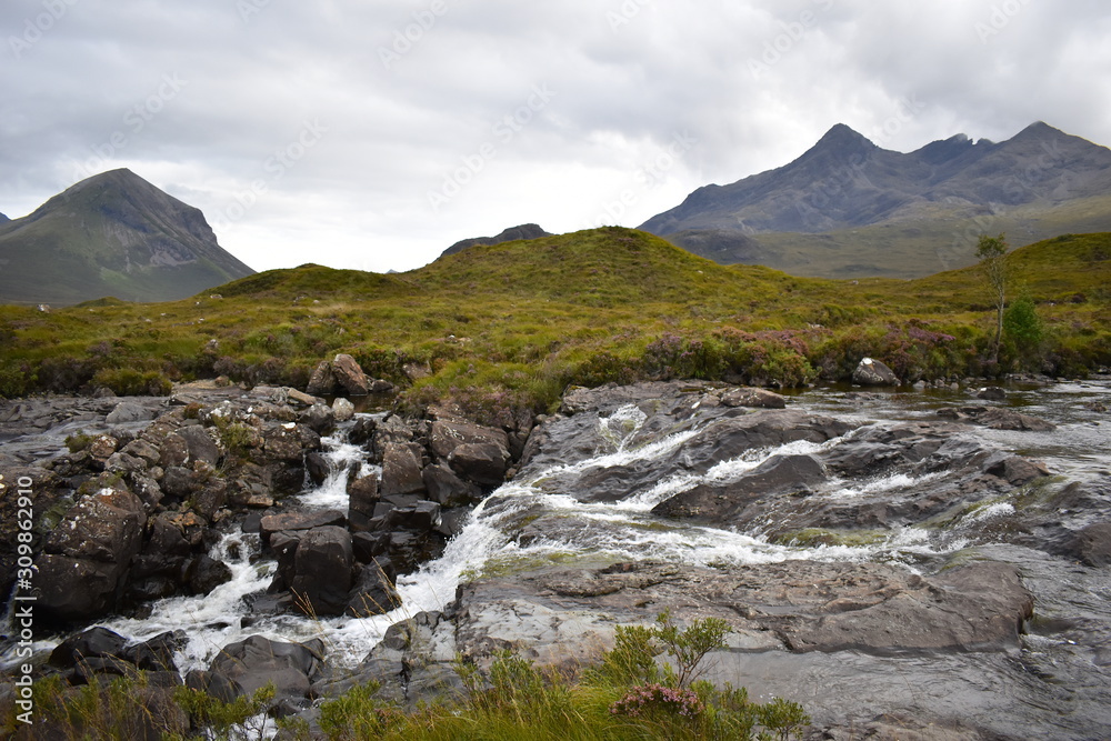 Spring down the hill at the foot of the Cuillin mountains in the Scottish highlands. Discover British wild plants and lush greenery on a moderate day hike.