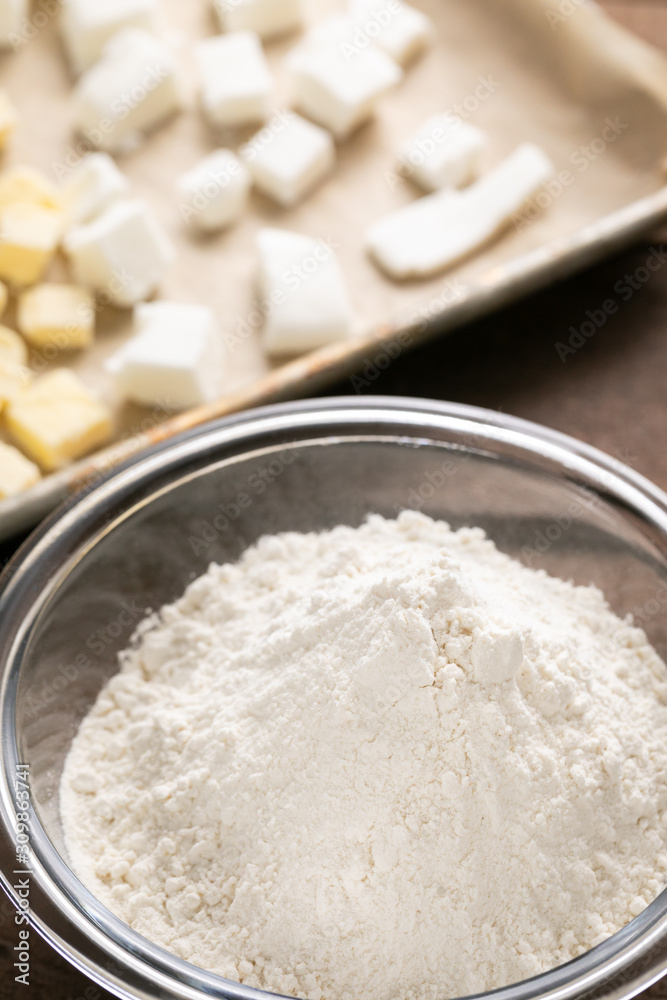 Baking flour with a sheet pan with shortening in the background Baking flour with a sheet pan with shortening in the background