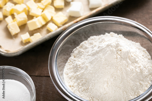 Baking flour and ingredients beside a sheet pan with butter photo