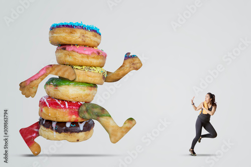 Tela Beautiful Asian woman being chased by doughnuts