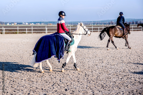 Horse riding . Young girl riding a horse . Equestrian sport in details.
