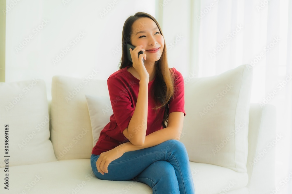 Portrait beautiful young asian women using mobile or smart phone on sofa Portrait beautiful young asian women using mobile or smart phone on sofa