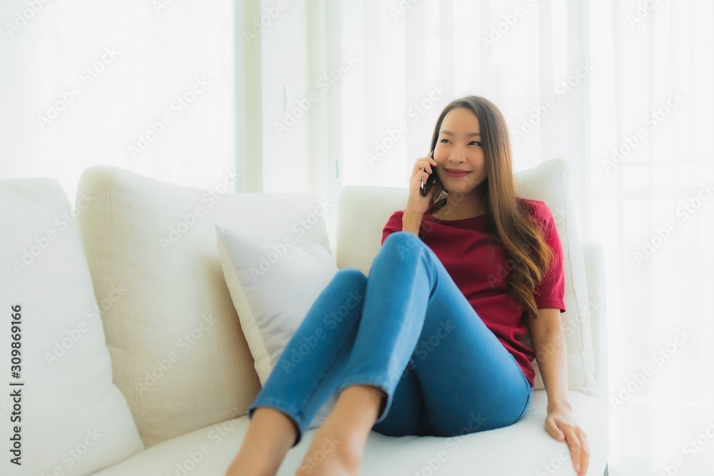 Portrait beautiful young asian women using mobile or smart phone on sofa Portrait beautiful young asian women using mobile or smart phone on sofa