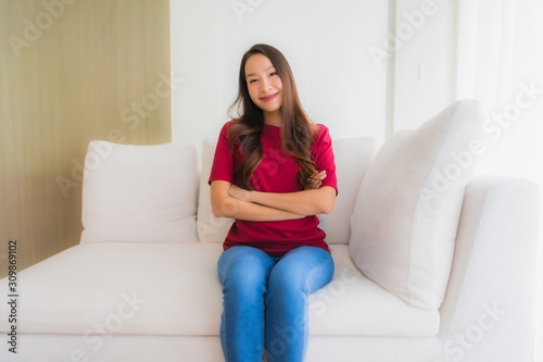 Portrait beautiful young asian women happy smile sit on sofa