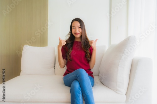 Portrait beautiful young asian women happy smile sit on sofa Free Download Portrait beautiful young asian women happy smile sit on sofa - GFXLoad