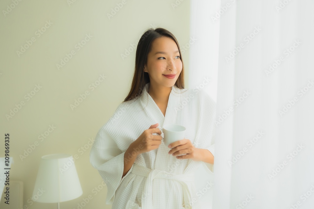 Portrait beautiful young asian women with coffee cup in bedroom