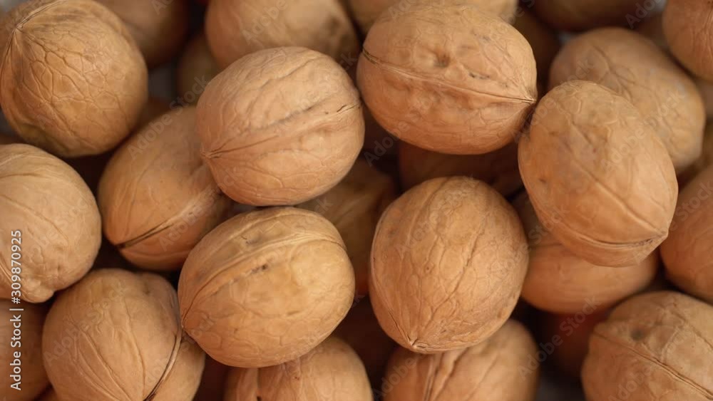 Walnut close up. product rich in minerals and vitamins. Walnut turns in a shot. Walnut kernels rotating. walnut close up lies under beams of the sun. Macro Walnut close up. product rich in minerals and vitamins. Walnut turns in a shot. Walnut kernels rotating. walnut close up lies under beams of the sun. Macro
