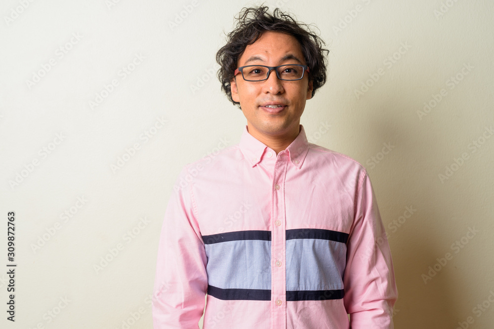 Portrait of Japanese businessman with curly hair wearing eyeglasses Portrait of Japanese businessman with curly hair wearing eyeglasses