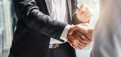 businessman handshake for teamwork of business merger and acquisition	 photo