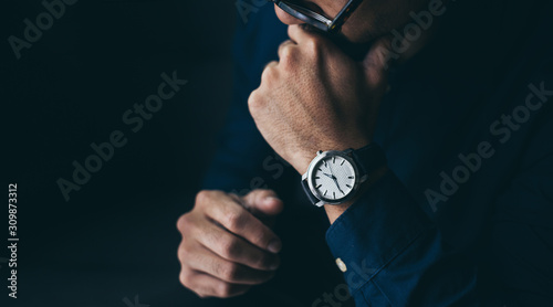 looking at luxury watch on hand check the time concept for managing time organization working,punctuality,appointment.fashionable wearing stylish photo