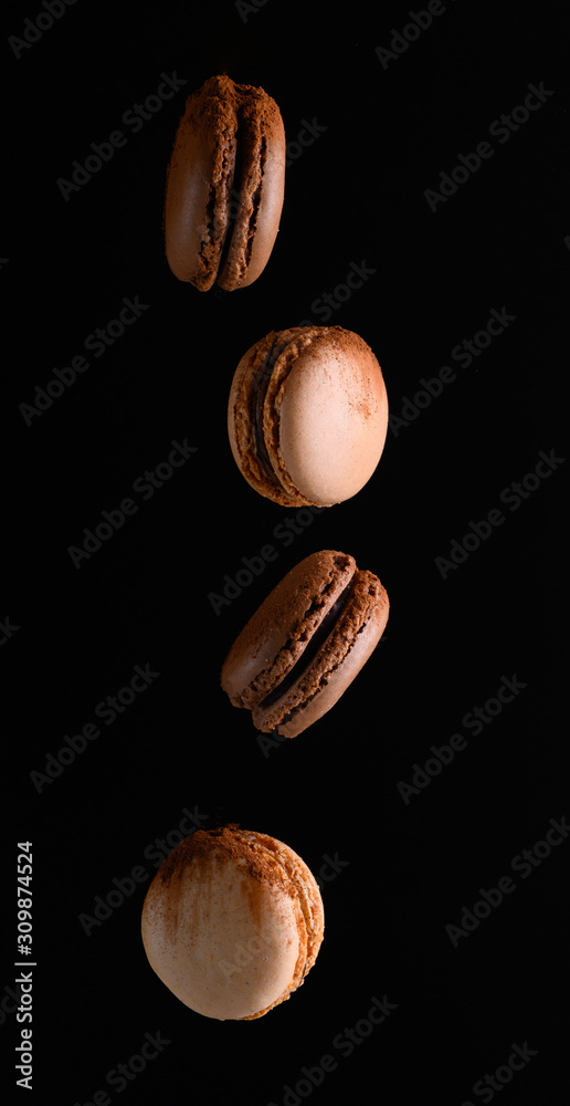 French chocolate and vanilla macaroons, drop or levitation. Advertising photo of sweets French chocolate and vanilla macaroons, drop or levitation. Advertising photo of sweets