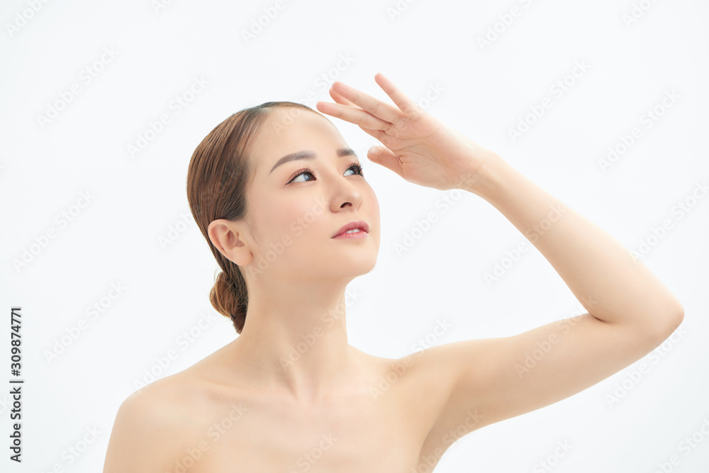 Portrait of young Asian woman looking to the side and showing hand on white background. Portrait of young Asian woman looking to the side and showing hand on white background.