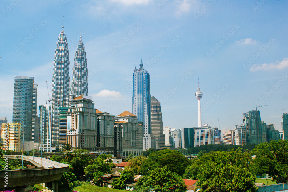 Kuala Lumpur, Malaysia - April 12, 2013. View from the bus window to the city center of Kuala Lumpur, view of the Petronas Towers and the Menard Tower.