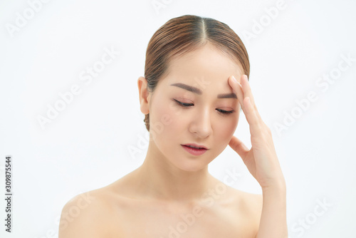 Emotional portrait of a tired and tensed young naked beautiful woman over white background.