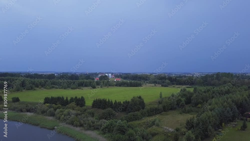 Aerial Shot of a Lightning Strike in a Distance over a Countryside.