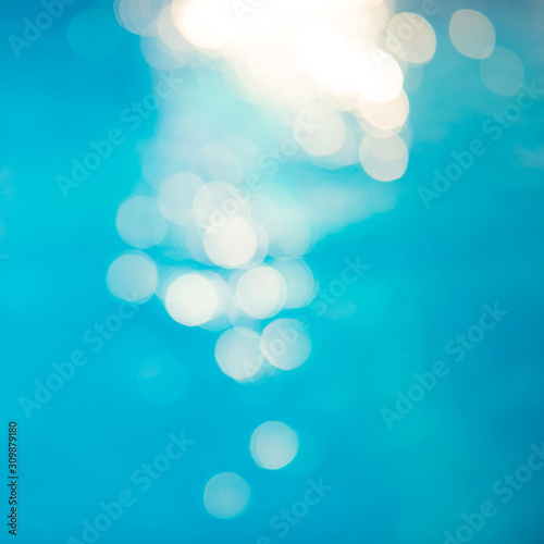 Bokeh light effects over a rippled, blue water background