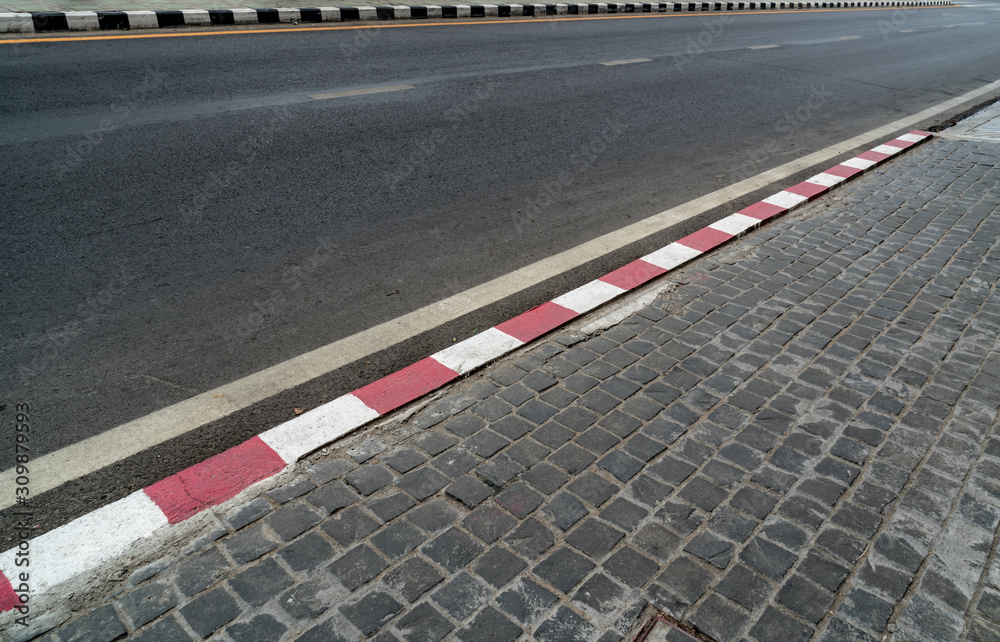 Fototapeta premium Road with red and white curb