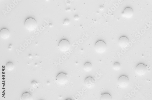 White liquid paint texture with round bubbles different sizes as simple abstract background.