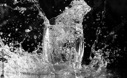 splashing water in a glass on a black background