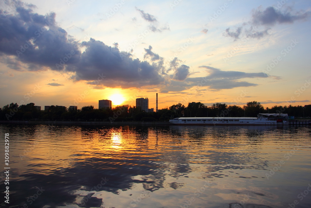 Moscow River urban landscape on beautiful evening sunset and ship on water background