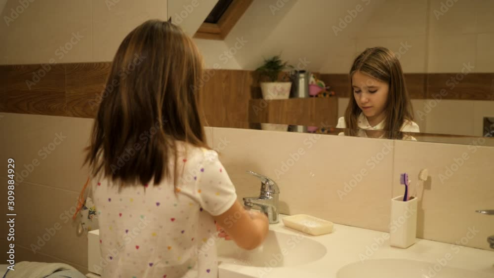 Cute kid girl hygiene washing hands lather with soap in bathroom in pajamas just after sleep in the morning Cute kid girl hygiene washing hands lather with soap in bathroom in pajamas just after sleep in the morning