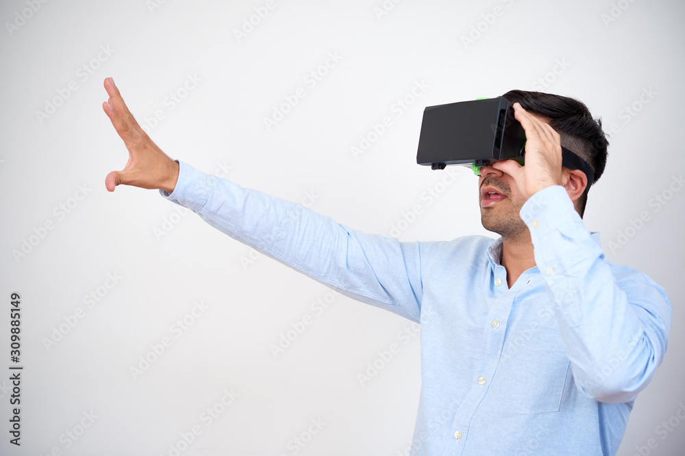 Businessman using virtual reality headset when working on presentation for ambitious project Businessman using virtual reality headset when working on presentation for ambitious project