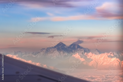 Mount Everest and mountain range during dusk seen from flight.