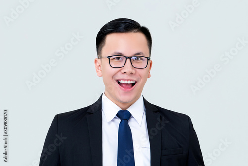 Delighted smiling Asian businessman in formal suit