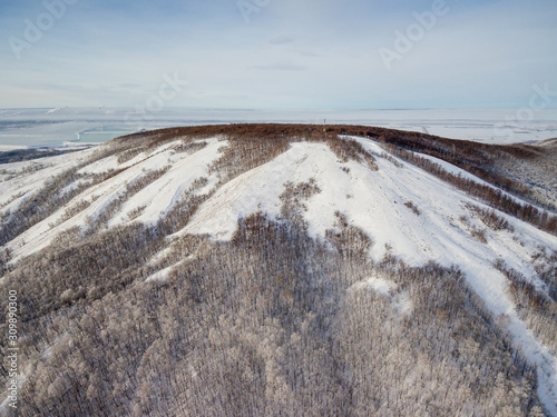 The remain of the reef of the ancient sea, composed of limestone - shikhan Kushtau in a winter day. Aerial view.