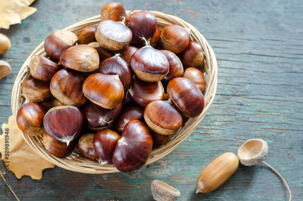 Edible chestnuts on the wooden table. Edible chestnuts on the wooden table.