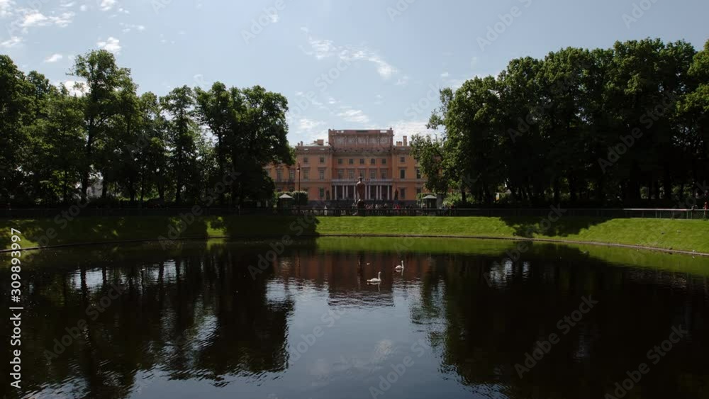 ST PETERSBURG, RUSSIA: Swan lake in the Summer Garden and The Mikhailovsky Castle in the summer day ST PETERSBURG, RUSSIA: Swan lake in the Summer Garden and The Mikhailovsky Castle in the summer day