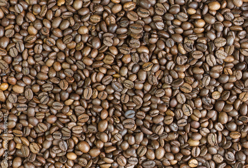 Coffee beans background top view. Arabica strong roast.