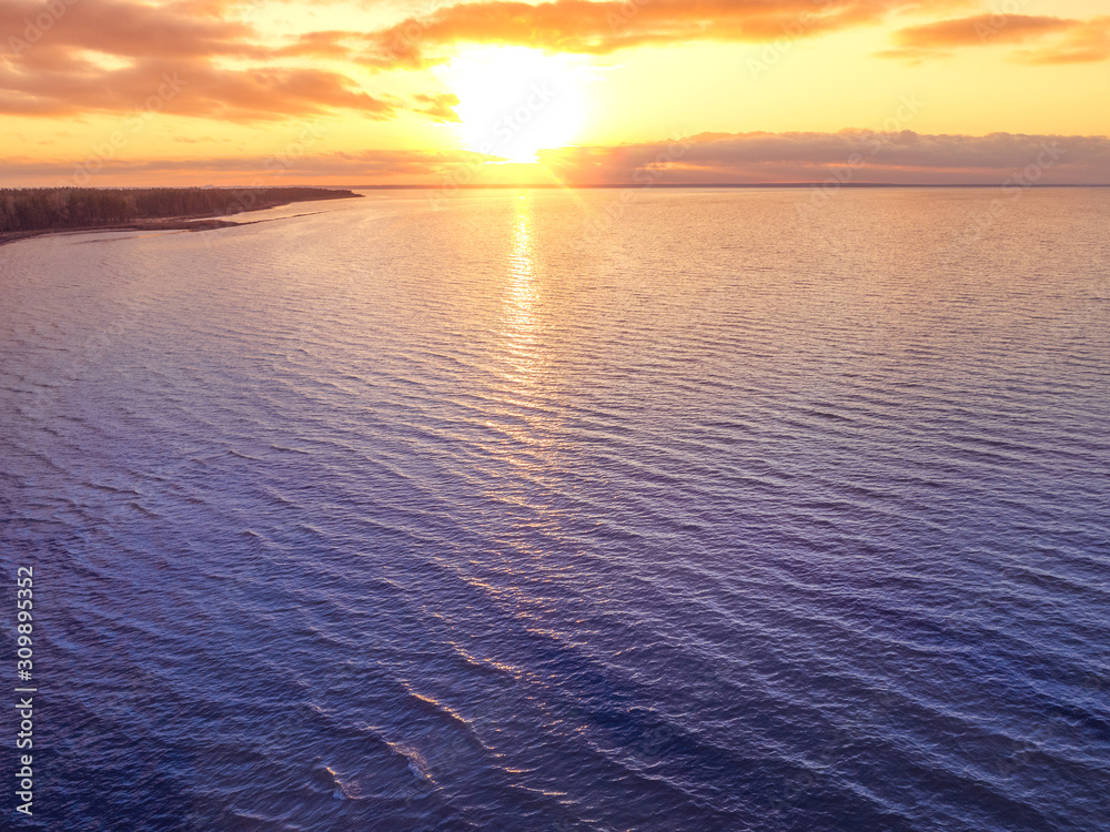Obraz premium Sunset over the sea. Sea landscape in the evening. Beautiful sunset with dramatic sky. Aerial view