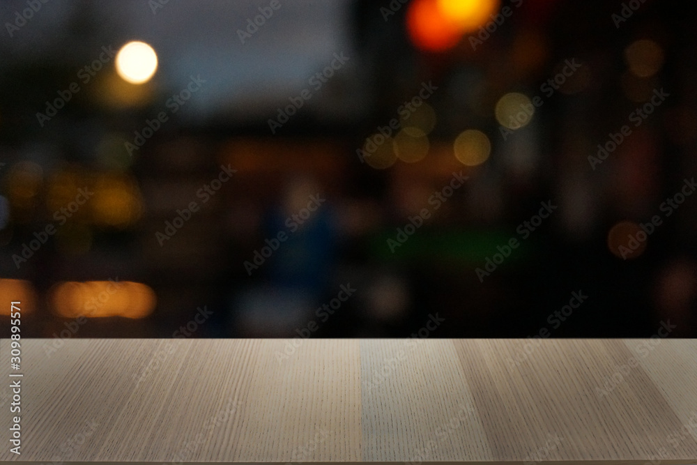 Empty dark wooden table in front of abstract blurred bokeh background of restaurant . can be used for display or montage your products.Mock up for space.