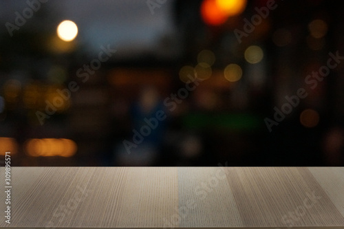 Empty dark wooden table in front of abstract blurred bokeh background of restaurant . can be used for display or montage your products.Mock up for space.