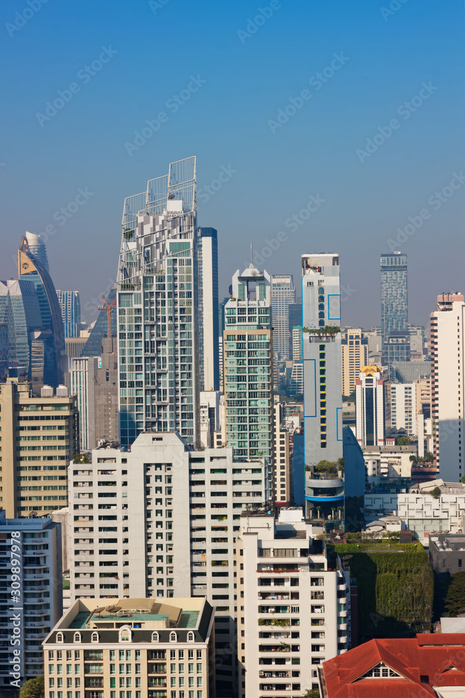 Naklejka premium Bangkok, Thailand – December 21, 2019 : Office Buildings, city and condominiums Area in Bangkok, Office Building in City, Modern Building, Businesses Building. Sky view from Asoke area. with blue sky.