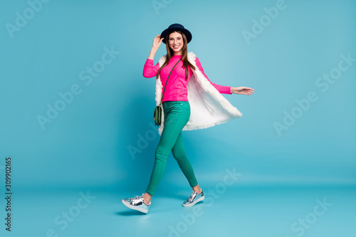 Full length body size view of her she nice-looking attractive lovely cheerful cheery girl walking spending weekend free spare time isolated on bright vivid shine vibrant green blue turquoise color