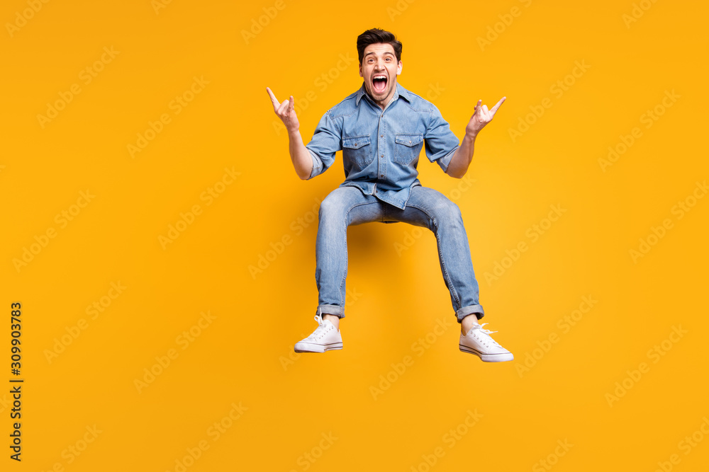 Full length body size photo of cheerful screaming crazy overjoyed man feeling impression after visiting concert of his favorite rock band showing horned finger isolated vivid color background