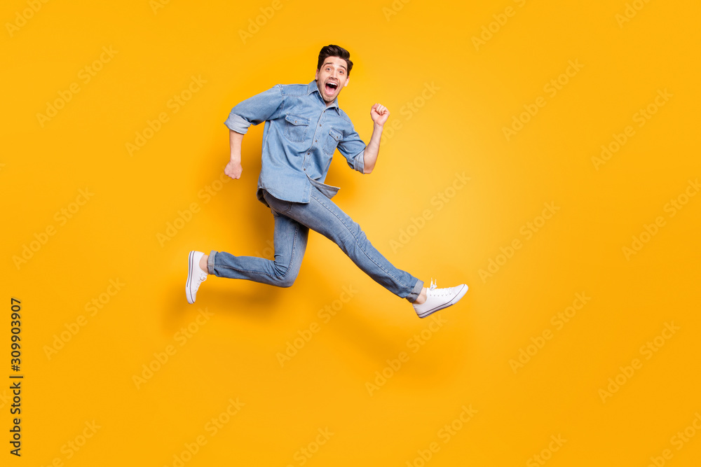 Full length body size view of his he nice attractive cheerful cheery overjoyed guy jumping running having fun isolated over bright vivid shine vibrant yellow color background Full length body size view of his he nice attractive cheerful cheery overjoyed guy jumping running having fun isolated over bright vivid shine vibrant yellow color background