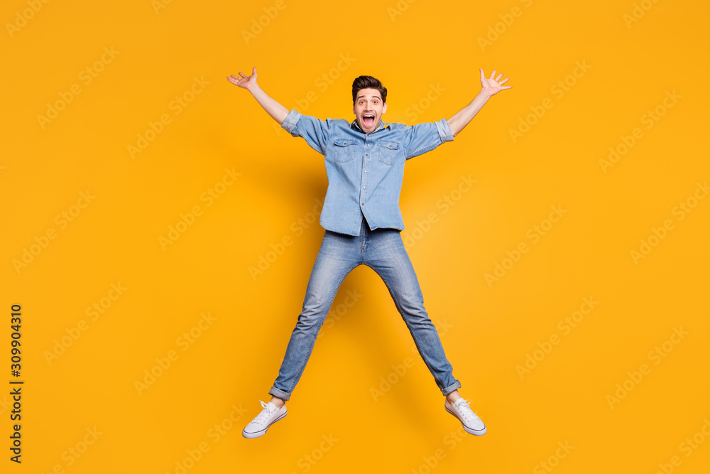 Full length body size photo of cheerful positive crazy overjoyed man shouting yes yeah in white t-shirt isolated vivid color background