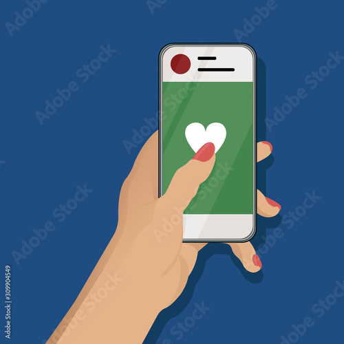 Female hand holding a smartphone and sending like to a social network on classic blue background.