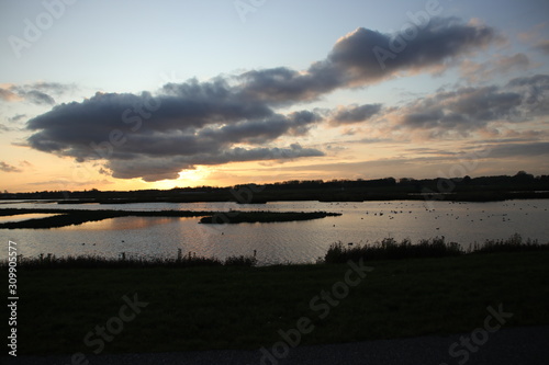 Sunset with colorful sky over the Eendragtspolder  used for water storage to prevent flooding of the city of Rotterdam