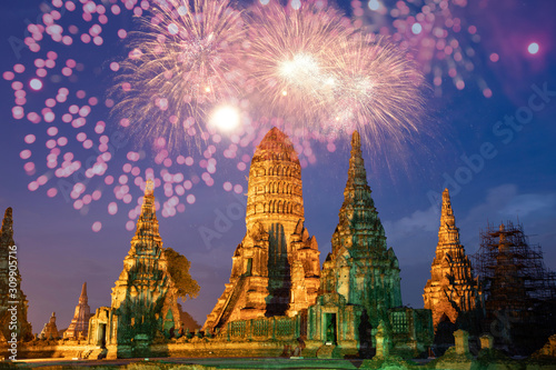 Beautiful Buddhist temple at night with fireworks for celebrations.