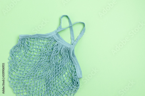 Top view of blue color reusable shopping bag on green background
