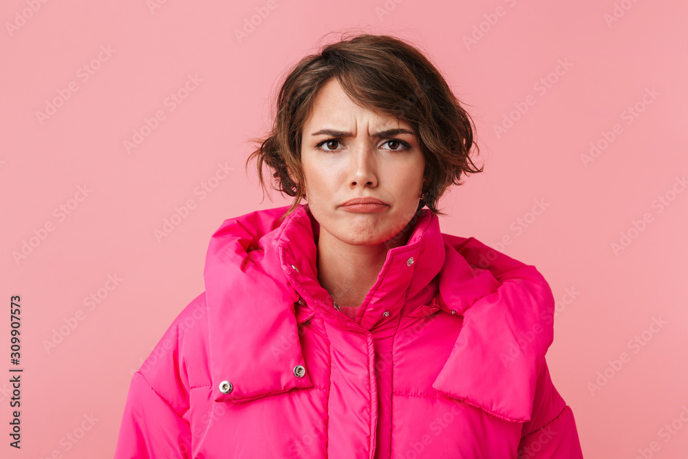 Portrait of displeased young woman posing and looking at camera Portrait of displeased young woman posing and looking at camera