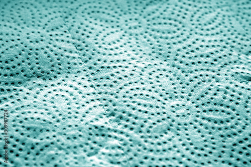 Paper towel surface with blur effect in cyan tone.