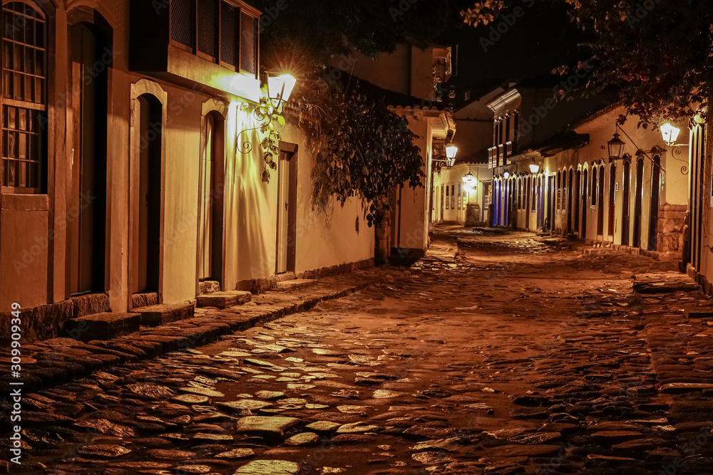 Atmospheric night view of illuminated street and buildings in historical center of Paraty, Brazil, Unesco World Heritage